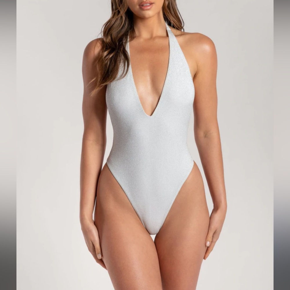 Meshki high waisted backless one piece in silver.